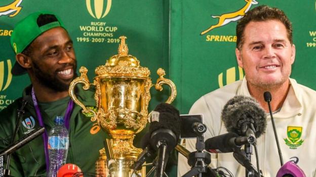 Siya Kolisi and Rassie Erasmus as part of South Africa's Rugby World Cup-winning squad in 2019