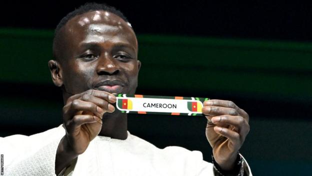 Senegal's footballer Sadio Mane shows the paper slip of Ghana during the Africa Cup of Nations (CAN) 2024 official football draw
