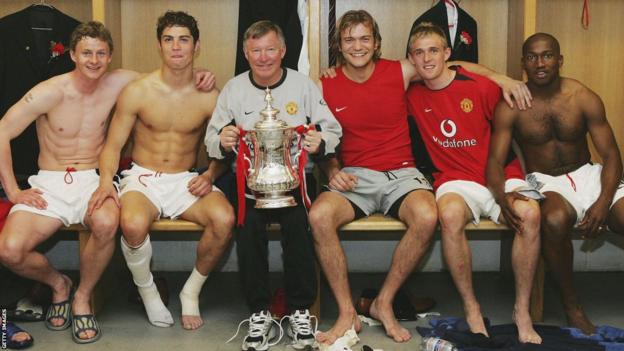 Manchester United's Ole Gunnar Solskjaer, Cristiano Ronaldo, Sir Alex Ferguson, Roy Carroll, Darren Fletcher and Eric Djemba-Djemba celebrate with the FA Cup in the dressing room after winning the final against Millwall in 2004