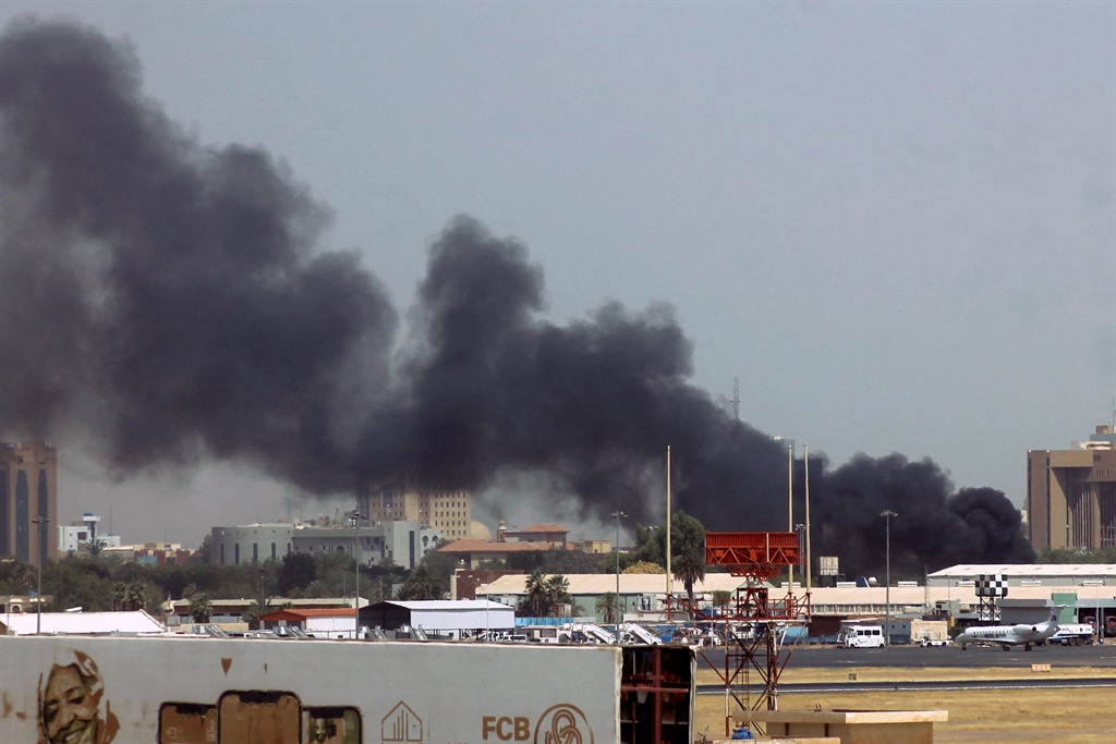 Heavy smoke bellows above buildings in the vicinity of the Khartoum's airport on April 15, 2023, amid clashes in the Sudanese capital. Explosions rocked the Sudanese capital on April 15 as paramilitaries and the regular army traded attacks on each other's bases, days after the army warned the country was at a 